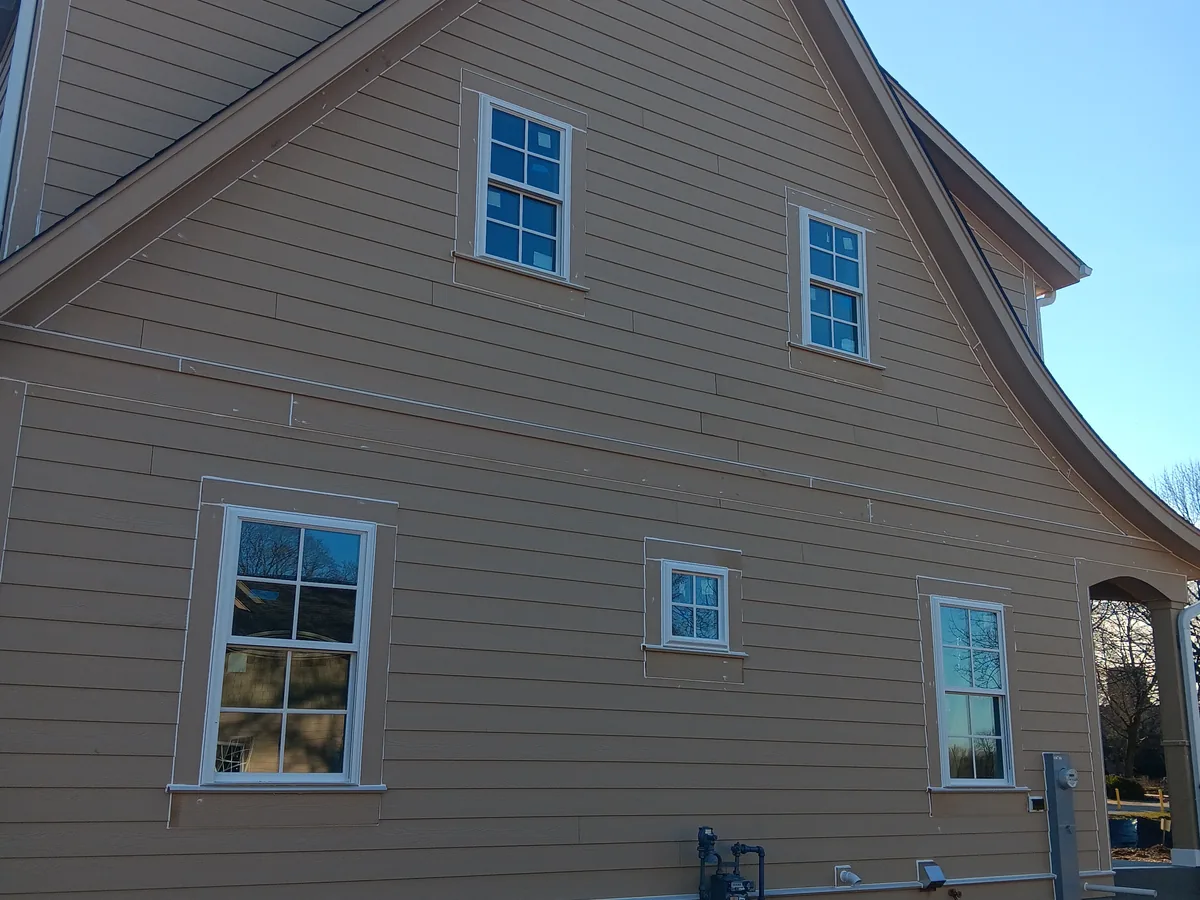 Finished exterior of a home with freshly painted siding and white trim