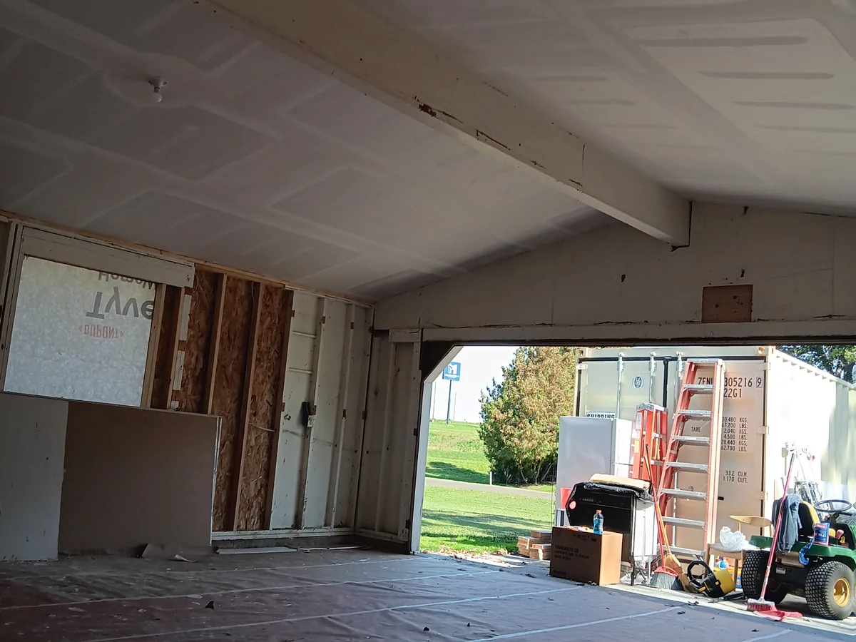 Unfinished attached garage interior with a bare concrete floor before finishing