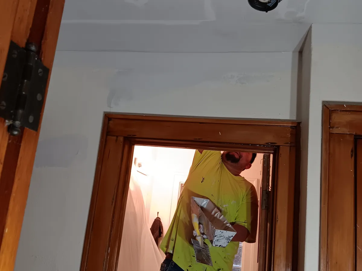 Painting an interior wall next to a stained wood door frame