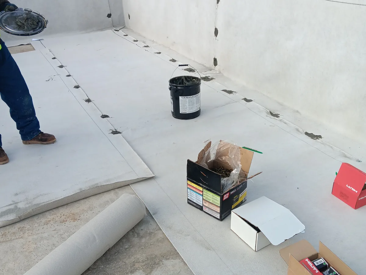 Interior room with a white coating applied across the floor during installation