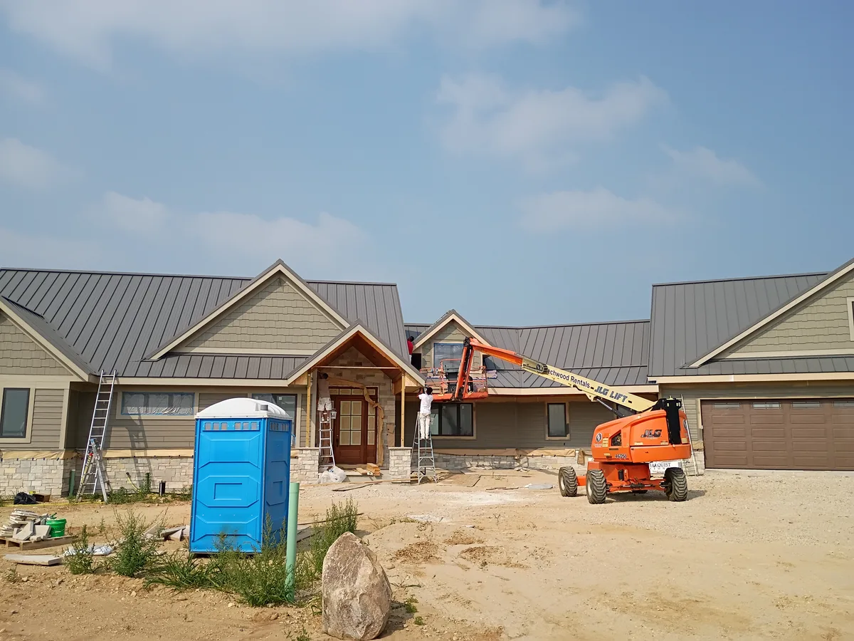 Home under construction with a lift parked at the front elevation